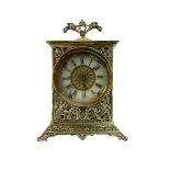 Small bedside table clock in a pierced brass case on a splayed plinth