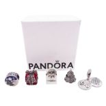 Five silver Pandora charms including Pandora shopping bag