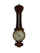 Early 20th century aneroid barometer c1910 in a scroll carved mahogany case with a silvered dial