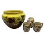 Victorian Leeds Art Pottery jardiniere decorated with flowers and foliage on a brown and yellow merg