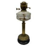 Early 20th century brass oil lamp with ornate foliate base and clear glass reservoir