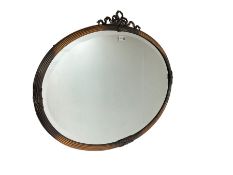 Early 20th century oval wall mirror with ribbon pediment