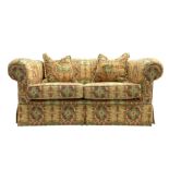 Two seat traditional shape sofa upholstered in Kilim print fabric
