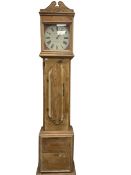 A contemporary pine cased longcase clock with a painted circular dial