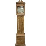 A contemporary pine cased longcase clock with a painted circular dial