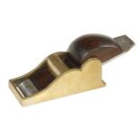 A brass chariot plane 3 3/4" x 1 1/2" with rosewood wedge and 3 small filled blow holes to sole G+