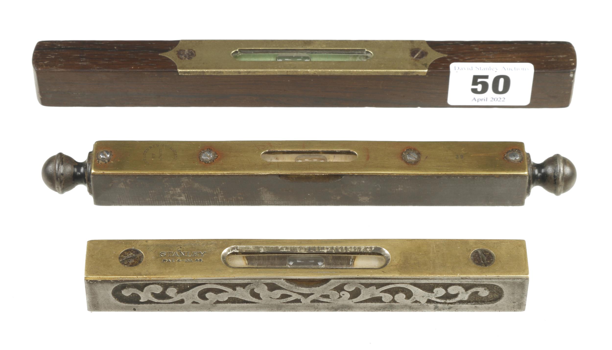 Two 6" steel and brass levels by STANLEY and DAVIS and an 8" rosewood level by HOWARTH G+
