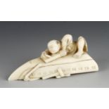 An ivory okimono of a boy planing the bottom of an upturned boat 3" x 1 1/2"h G++