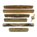 A decorative but worn rosewood and brass level by BUIST and 5 other brass topped levels and a