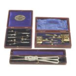 A proportional divider, a set of 3 bow compasses and a set of brass trammel heads all in orig