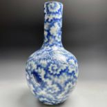 A Chinese blue and white porcelain vase, early 20th century, decorated with a stylised dragon