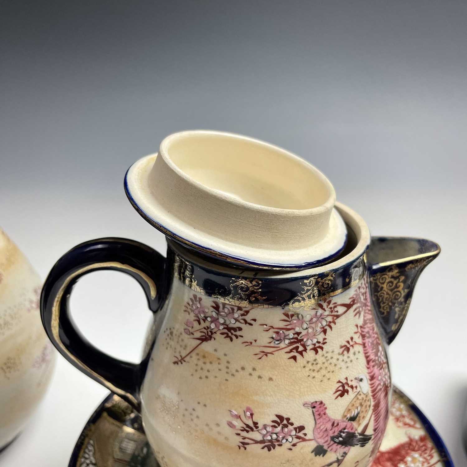 A Japanese satsuma tea service, early 20th century, comprising a teapot, hot water jug, sugar - Image 3 of 18