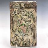 A Persian tin glazed pottery tile, 19th century, relief decorated with a horse, rider and bird of