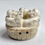 A Japanese ivory netsuke of two figures with a flask and cup, Meiji period, height 3cm, width 4cm,