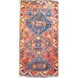 A Yuruk rug, circa 1900, South East Anatolia, the madder field with a triple linked medallion,