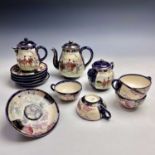 A Japanese satsuma tea service, early 20th century, comprising a teapot, hot water jug, sugar