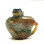 A Chinese jade snuff bottle, 20th century, carved with foliage to each side and with a shaped handle