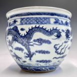 A Chinese blue and white porcelain jardiniere, the prunus blossom decorated rim above two stylised