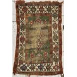 A Turkish tribal rug, 19th century, the green field with a large madder medallion filled an ivory