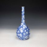 A Chinese prunus pattern bottle vase, 19th century, with a blue cracked ice ground, height 31cm,