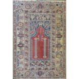 A Turkish prayer rug, circa 1920, the madder mihrab within multiple borders, 197 x 136cm.Condition