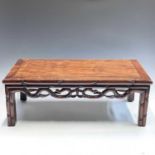 A Chinese hardwood Kang table, with a pierced frieze on square section legs, height 27cm, width