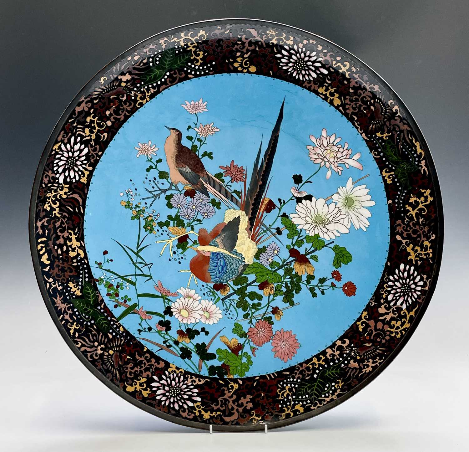 A huge Japanese cloisonne charger, Meiji Period, the sky blue ground decorated with birds amongst