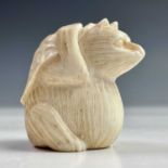 A Japanese ivory netsuke of a possum beneath a leaf, Meiji period, signed, height 4cm, width 3cm,