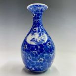 A Japanese blue and white porcelain vase, 20th century, with cracked ice ground with flowerheads,