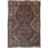 A Khamseh rug, Shiraz region, South West Persia, the indigo and madder linked medallions with