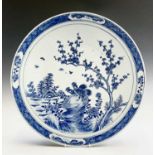A Chinese blue and white porcelain charger, 19th century, with birds perched on a blossoming tree