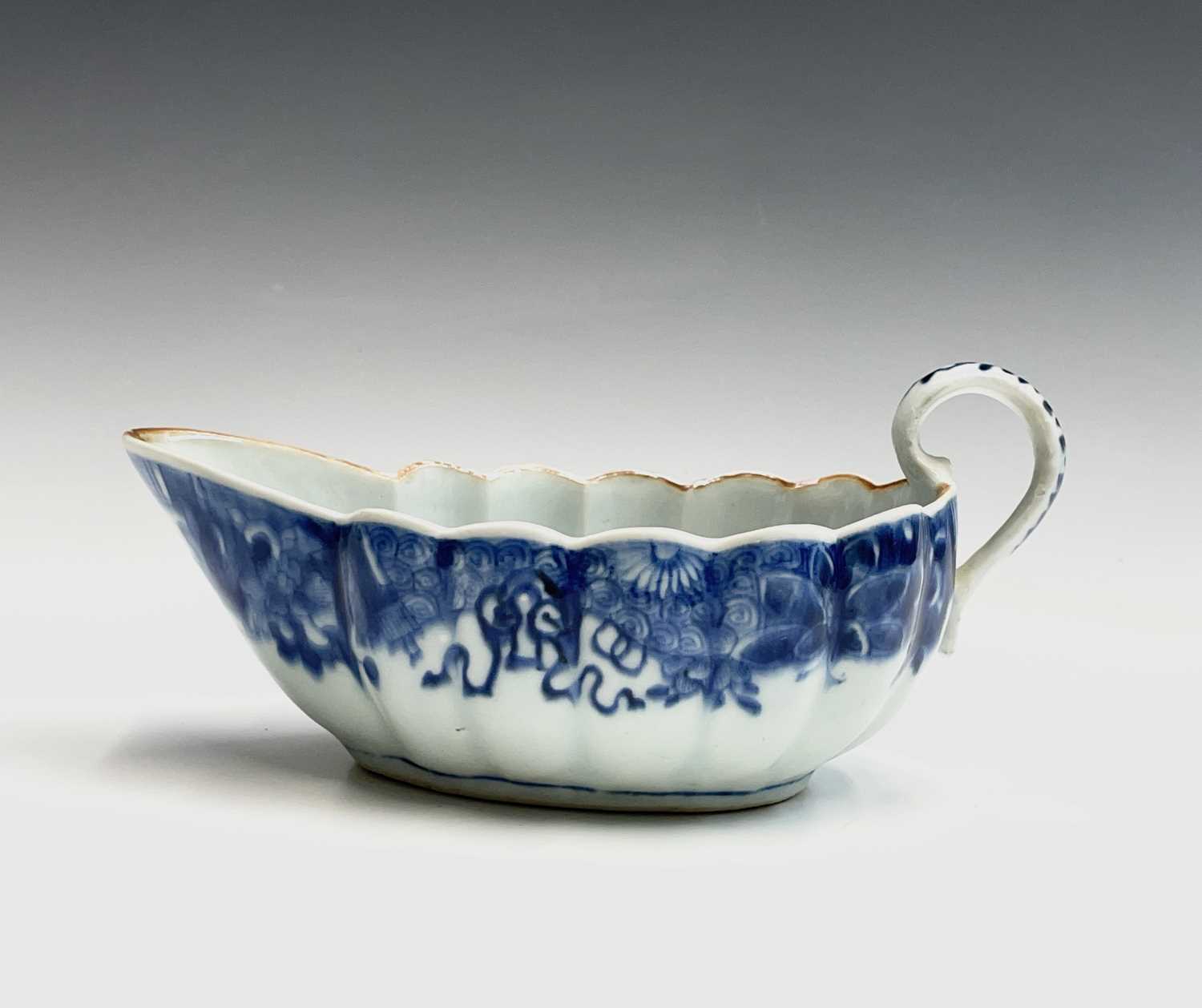 A Chinese Export porcelain sauce boat, 18th century, the interior with birds, a tree and flowers