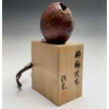 A Japanese Ikebana stoneware vase, signed, in wooden box with black character marks, height of