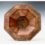 A Chinese hexagonal softwood bowl, early 20th century, decorated with stylised fish to the centre,