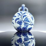 A Chinese blue and white porcelain moon flask, painted in the early Ming style with fruiting