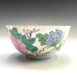 A Chinese famille rose porcelain bowl, 18th century, painted with a phoenix amongst flowering