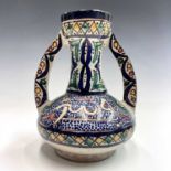 A Moroccan pottery twin-handled vase, mid 20th century, with calligraphy and geometric motifs,