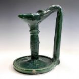 An Islamic green glazed pottery oil lamp, 19th century, height 24.5cm.