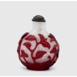 A Chinese overlay glass snuff bottle, mid-late 19th century, the red overlay carved with stylised