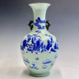 A Chinese celadon porcelain baluster vase, Qing Dynasty, decorated in blue and white with figures in