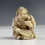 A Japanese ivory netsuke, Meiji period, signed, height 3cm, width 2.2cm.