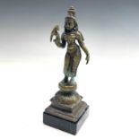 An Indian bronze figure of Meenakshi, early 20th century, holding a bird in her right hand, on a