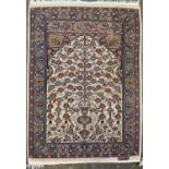 A Persian design prayer rug, mid 20th century, the ivory mihrab with a stylised tree and foliage,