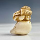 A Japanese ivory netsuke of a snail on a persimmon, Meiji period, signed, height 4.5cm, width 3cm.