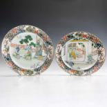 Two similar Chinese famille verte porcelain plates, circa 1800, decorated with interior and garden