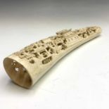 A Chinese carved ivory tusk, circa 1920, with figures, trees, pagodas and horses, height 6cm, length