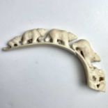 An inuit carving on walrus tusk carved with bears, circa 1910, with old damage and repaired with