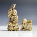 A small Japanese ivory netsuke of a seated boy, Meiji period, height 2.5cm and a Japanese okimono of