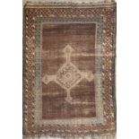 A Shiraz rug, South West Persia, the brown ground with a central polychrome medallion, within
