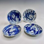 Four Chinese provincial blue and white dishes, Ming Dynasty, each depicting a stylised dragon,